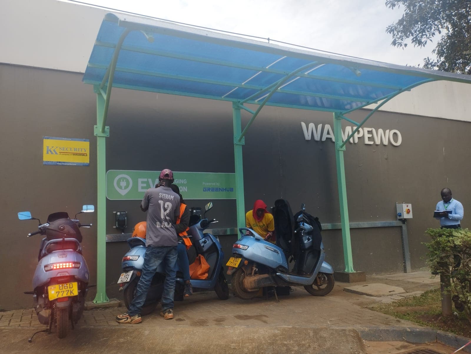 Electric two-wheelers parked and charging under a Chaji shelter