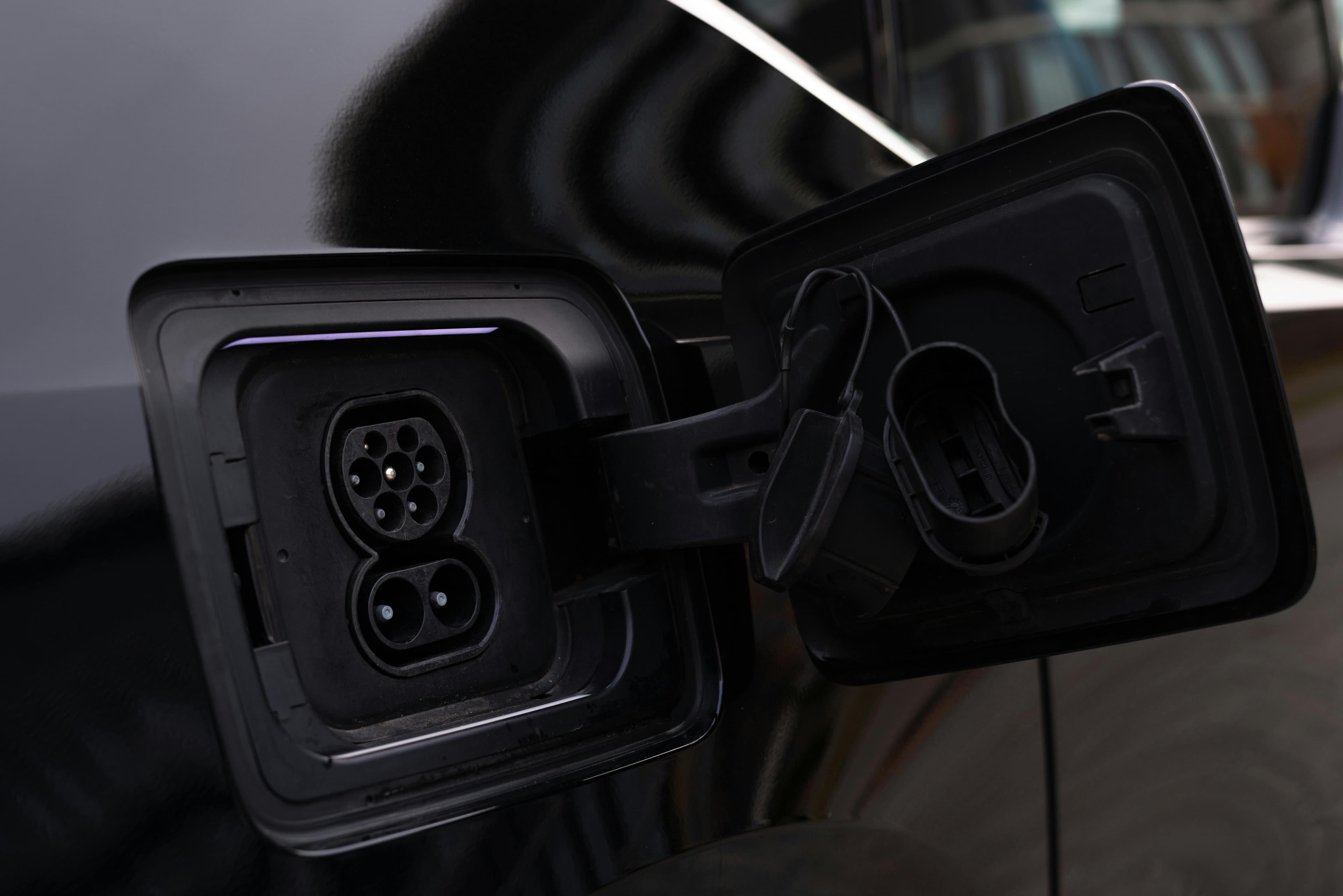 A charging connector seated in an electric vehicle's socket